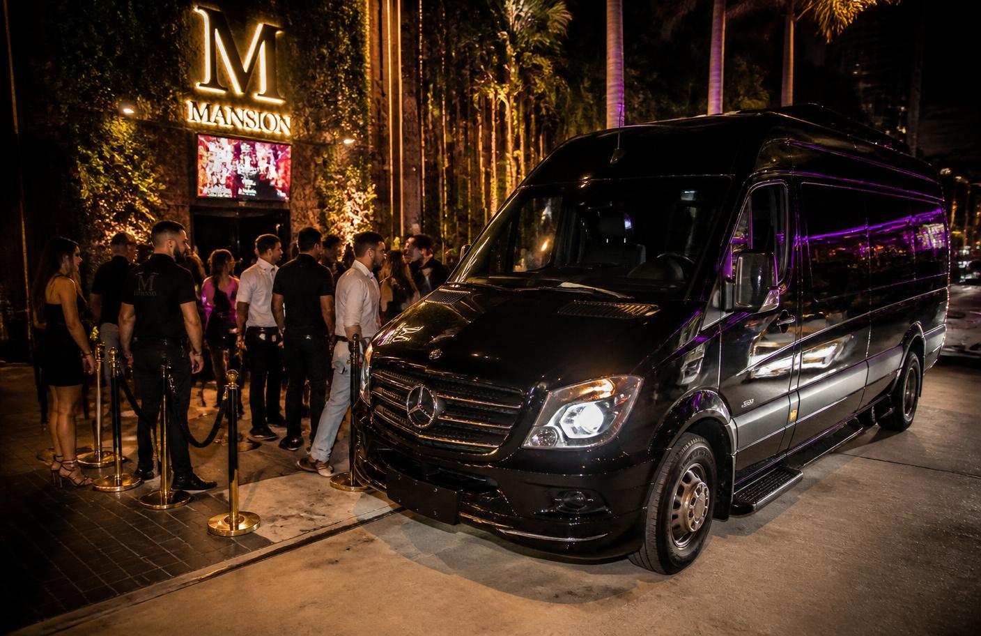 Black Mercedes Sprinter limo van waiting outside a South Florida nightclub